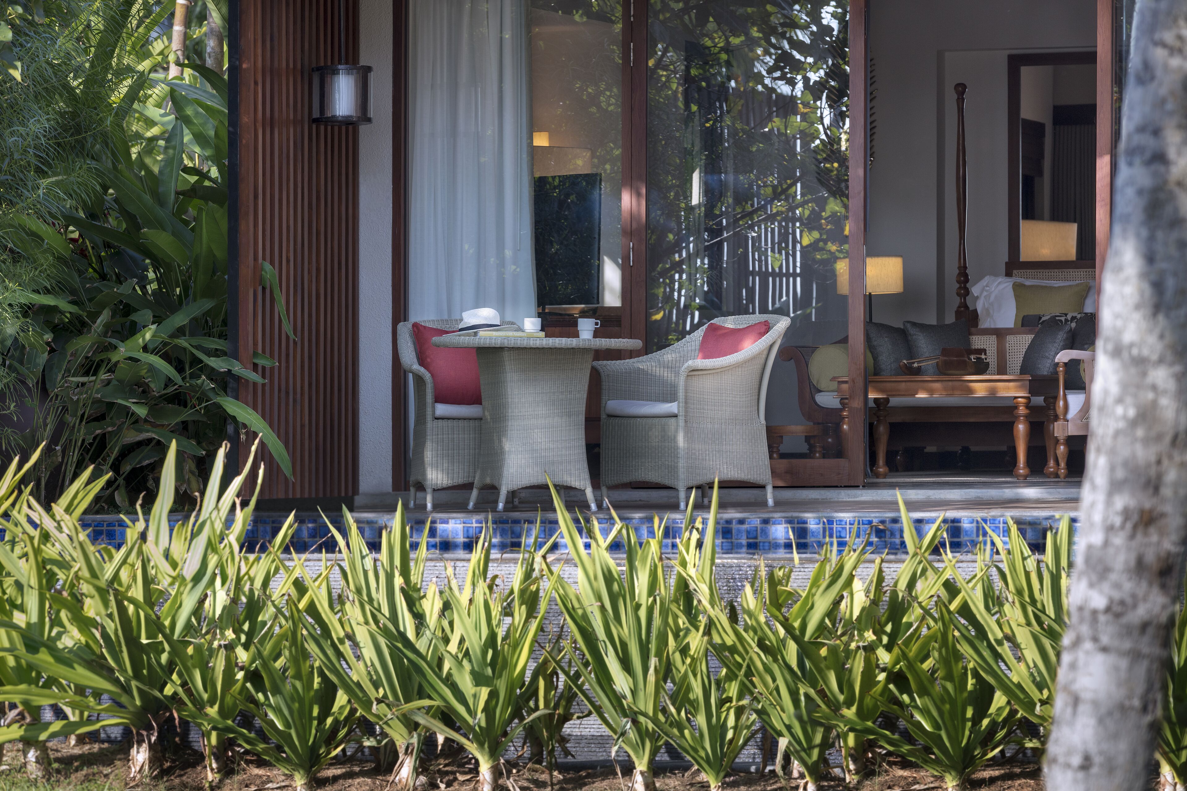 A well-lit room with a large window, a dining table with chairs, and a view of the outdoors.