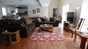 A living room with a sofa set, a coffee table, and a television. - House on Pond Court (Galena)