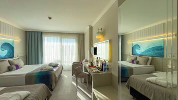 A hotel room with two beds, a desk with a chair, a TV, and artwork on the walls.