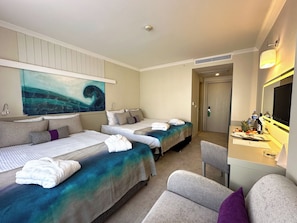 A hotel room with two beds, a desk with a mirror, a television, and a painting on the wall. - Catamaran Quality Times - All Inclusive (Kemer)