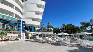 A resort with a pool area, sun loungers, and a modern building with balconies. - Catamaran Quality Times - All Inclusive (Kemer)