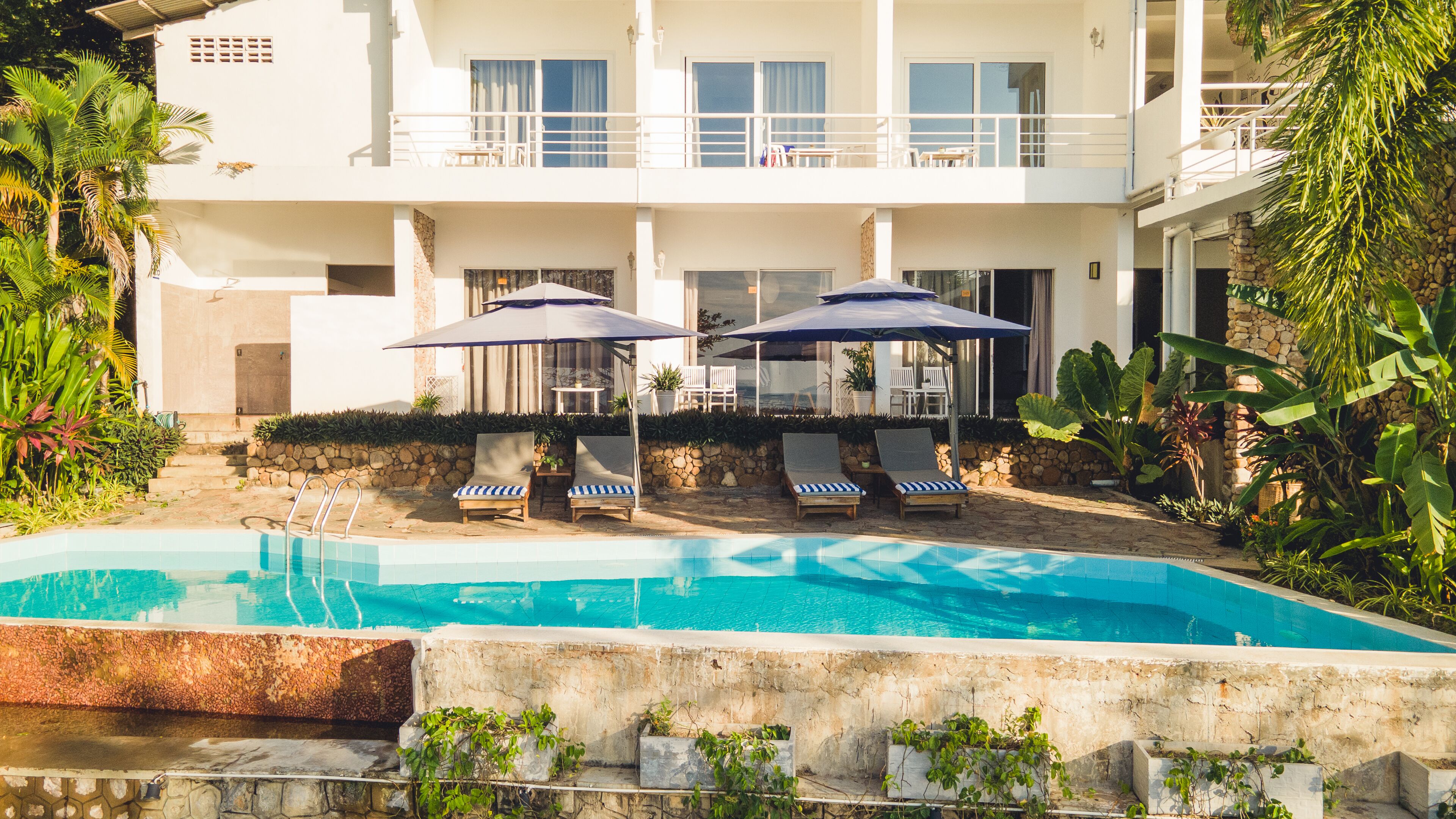 outdoor pool, pool umbrellas, pool loungers