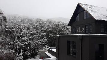 A building with a sign reading "Alk" amidst a snowy landscape.