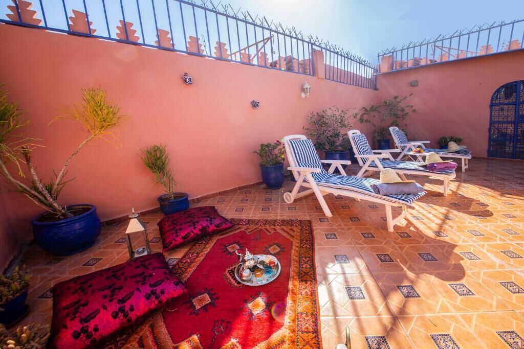 An outdoor seating area with lounge chairs and potted plants.