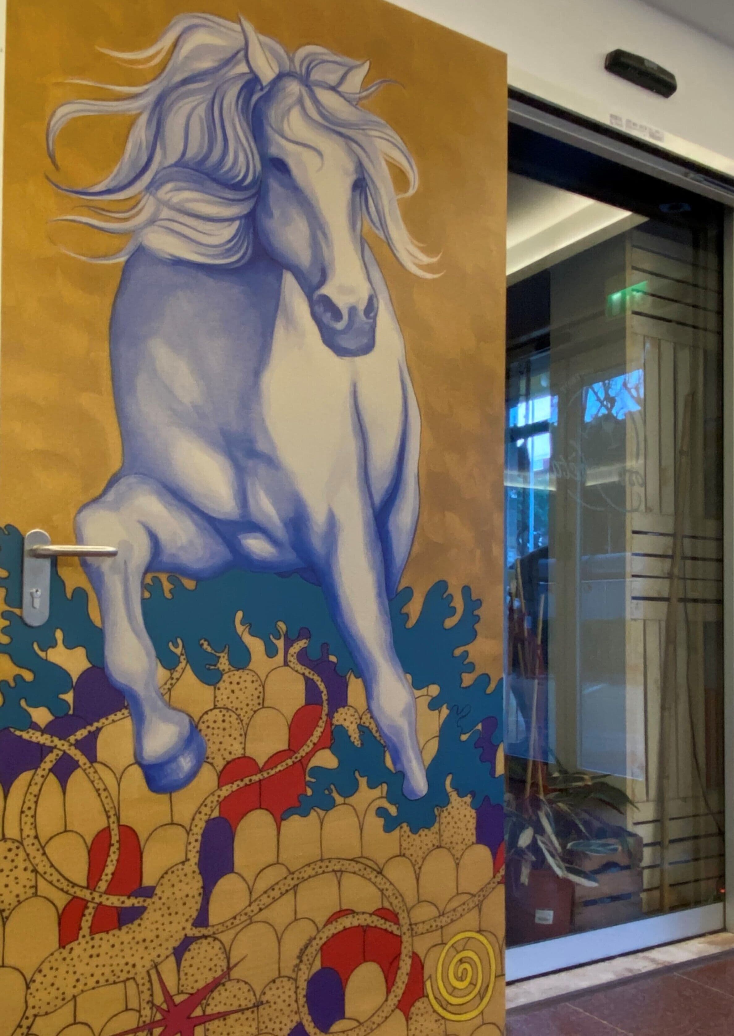 A mural of a horse on a wall.