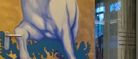A mural of a horse on a wall.