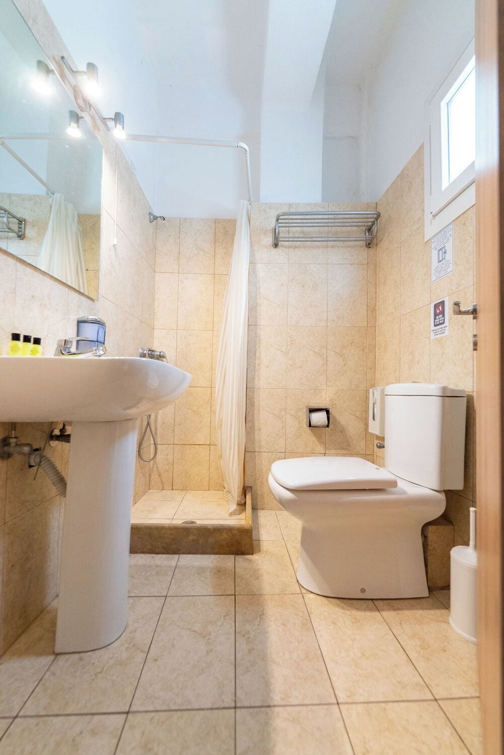 A modern bathroom with a sink, toilet, and shower.