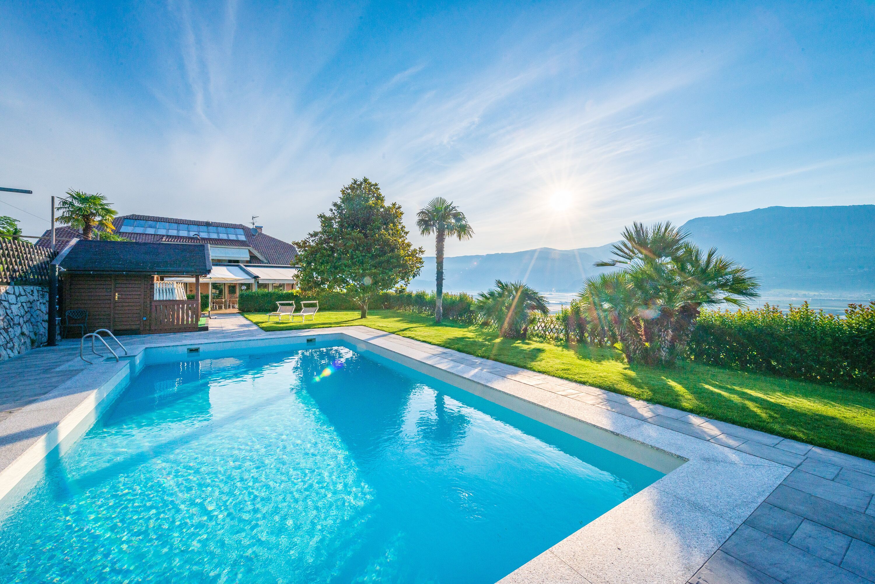 A swimming pool with a clear view of the mountains in the background.
