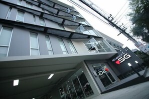 A modern building with a 5G sign, large windows, and a flat facade. - Residence SG (Chiang Mai)
