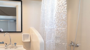 A bathroom with a shower, sink, and toilet. - Villa Toula (Santorini)