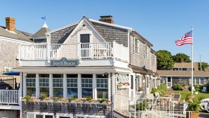 A two-story building with a balcony and a sign that reads "Inn on the Beach". - Inn on the Beach  (Harwich Port)
