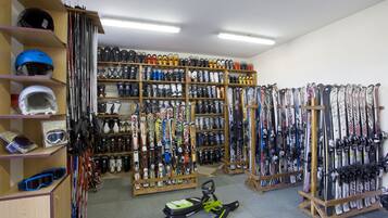 A ski equipment store with shelves of skis, snowboards, and helmets.