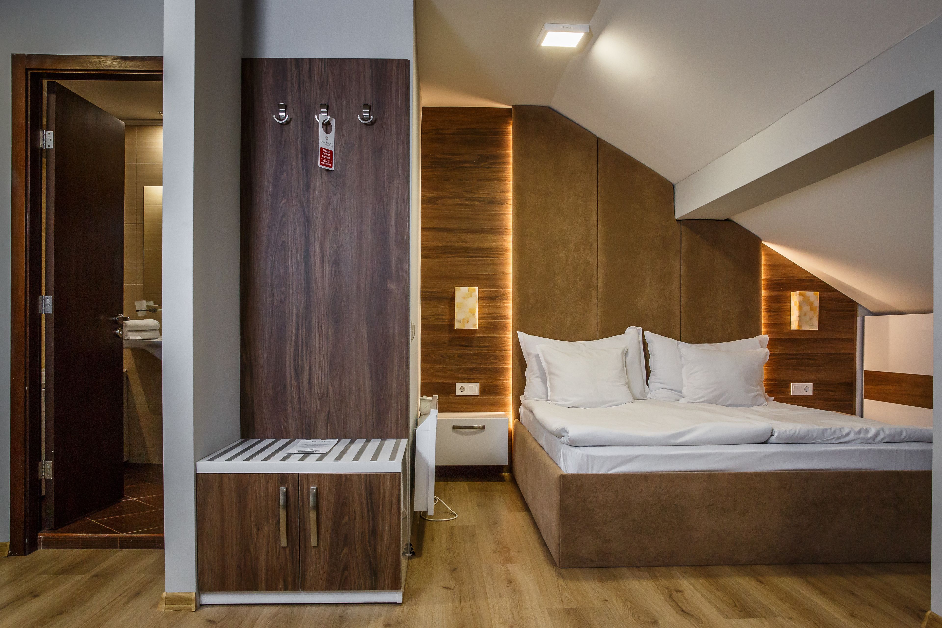 A modern bedroom with a built-in wardrobe, a bedside table, a nightstand, and a bed.