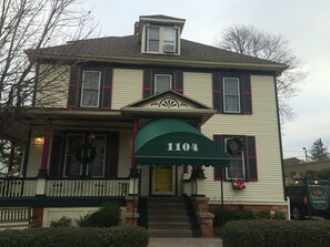 Classic two-story building with a symmetrical facade and pitched roof.
