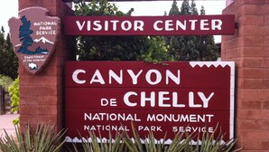 A visitor center sign for Canyon de Chelly National Monument. - Navajoland Inn (St. Michaels)