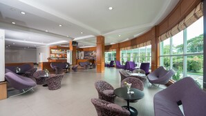 A spacious lobby with modern seating, large windows, and a reception area. - Sky Star Hotel (Yangon)
