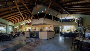 A spacious lobby with a central reception desk, multiple seating areas, and a high ceiling with exposed beams. - Hotel Fazenda Pocos de Caldas (Poços de Caldas)