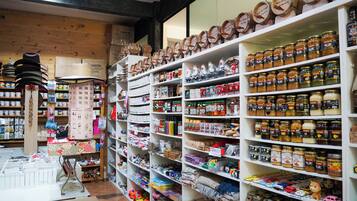 A store with shelves stocked with jars of honey and other food items.