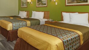 A hotel room with two beds, green walls, and three paintings. - Quality One Motel (Weatherford)