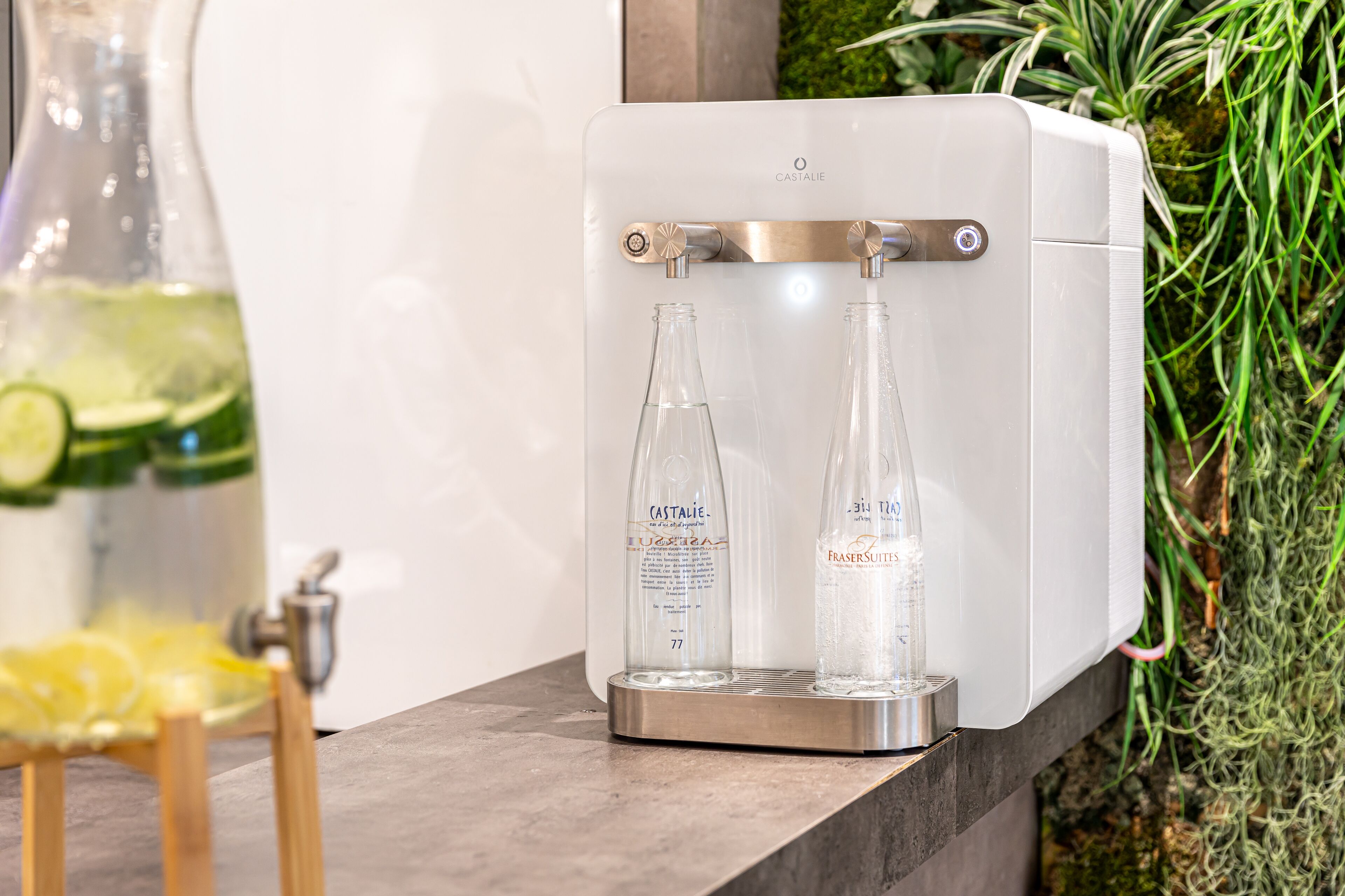 A water dispenser with two bottles labeled Castalie and Frasersuits.