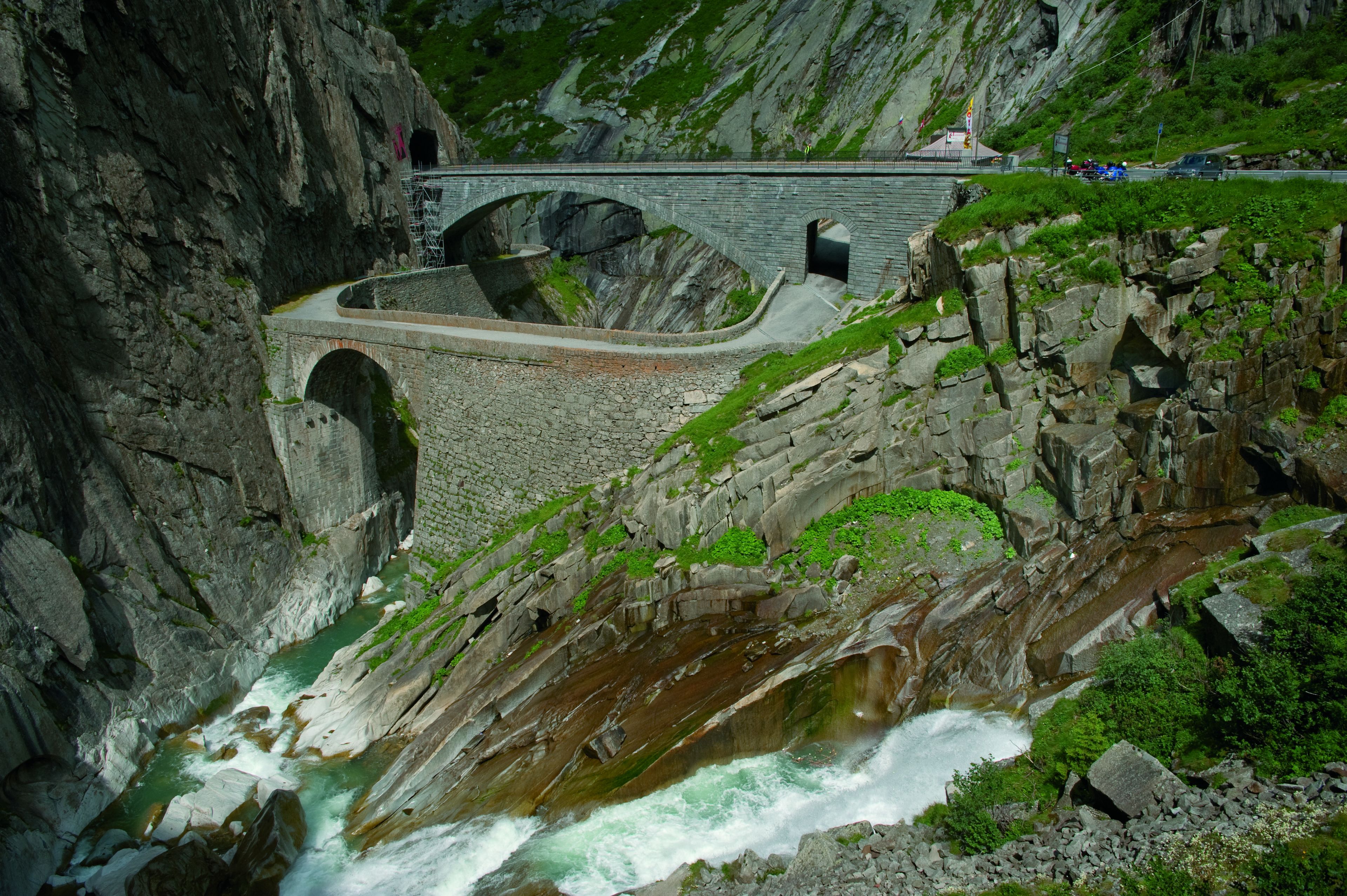 A stone bridge over a river with a rocky gorge.