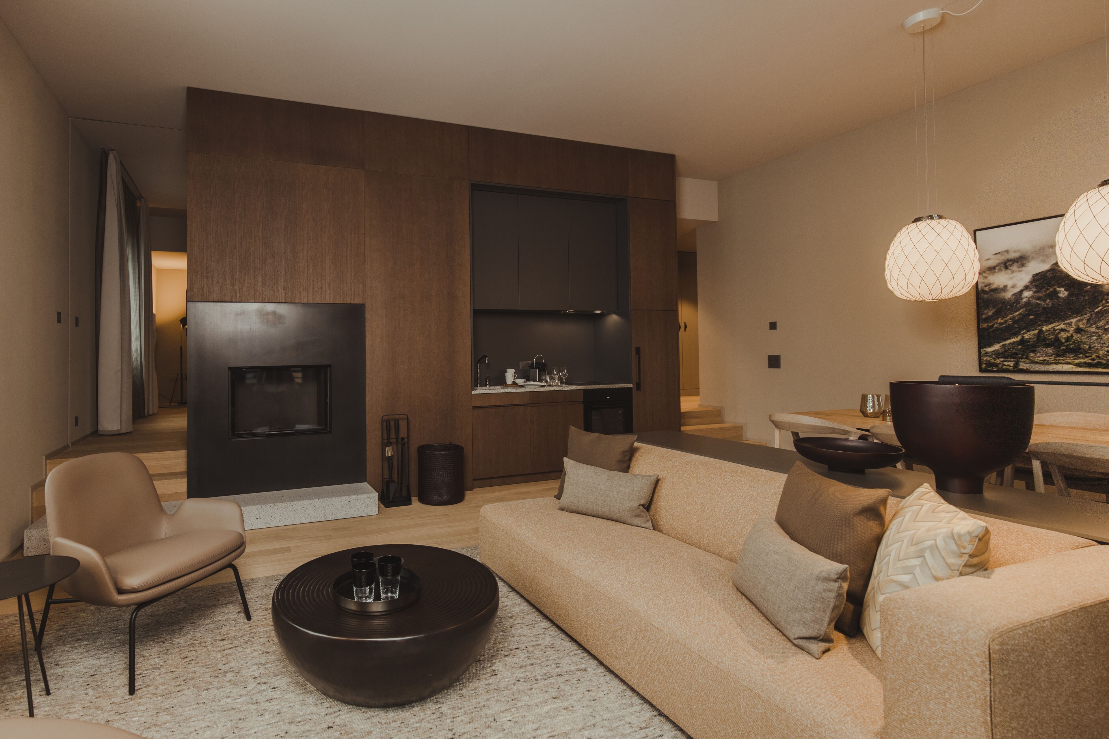 A modern living room with a sofa, coffee table, and a fireplace.