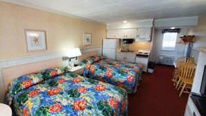 A compact hotel room with two beds, a small kitchenette, a dining area, and a bathroom. - The Shangri La Motel (Ocean City)