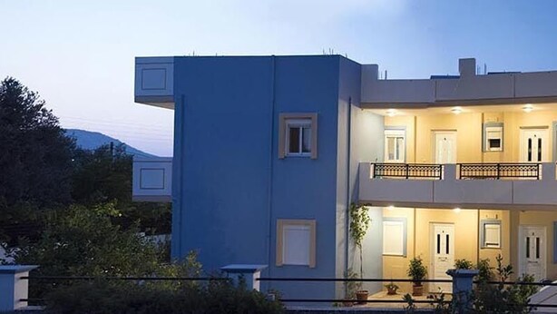 A modern two-story building with a balcony on the upper floor, surrounded by greenery. - Nephele Apartments (Rhodes)