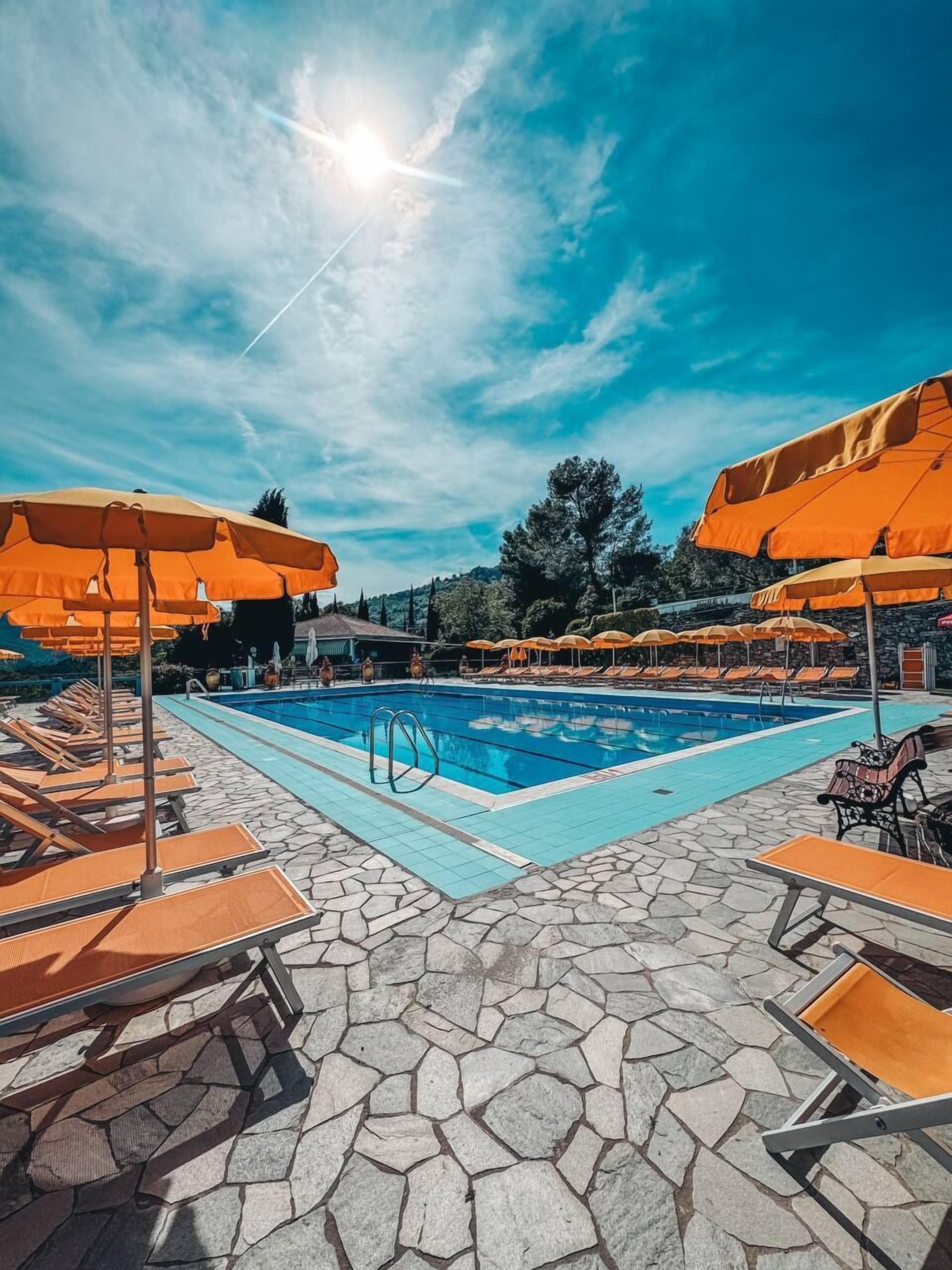 Seasonal outdoor pool, open 10:00 AM to 6:00 PM, pool umbrellas