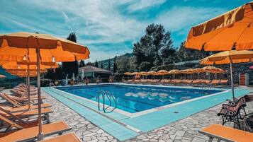 Seasonal outdoor pool, open 10:00 AM to 6:00 PM, pool umbrellas