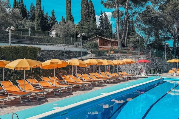 Seasonal outdoor pool, open 10:00 AM to 6:00 PM, pool umbrellas
