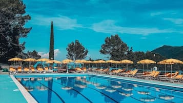 Seasonal outdoor pool, open 10:00 AM to 6:00 PM, pool umbrellas