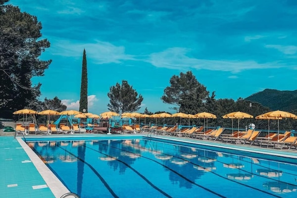 Seasonal outdoor pool, open 10:00 AM to 6:00 PM, pool umbrellas