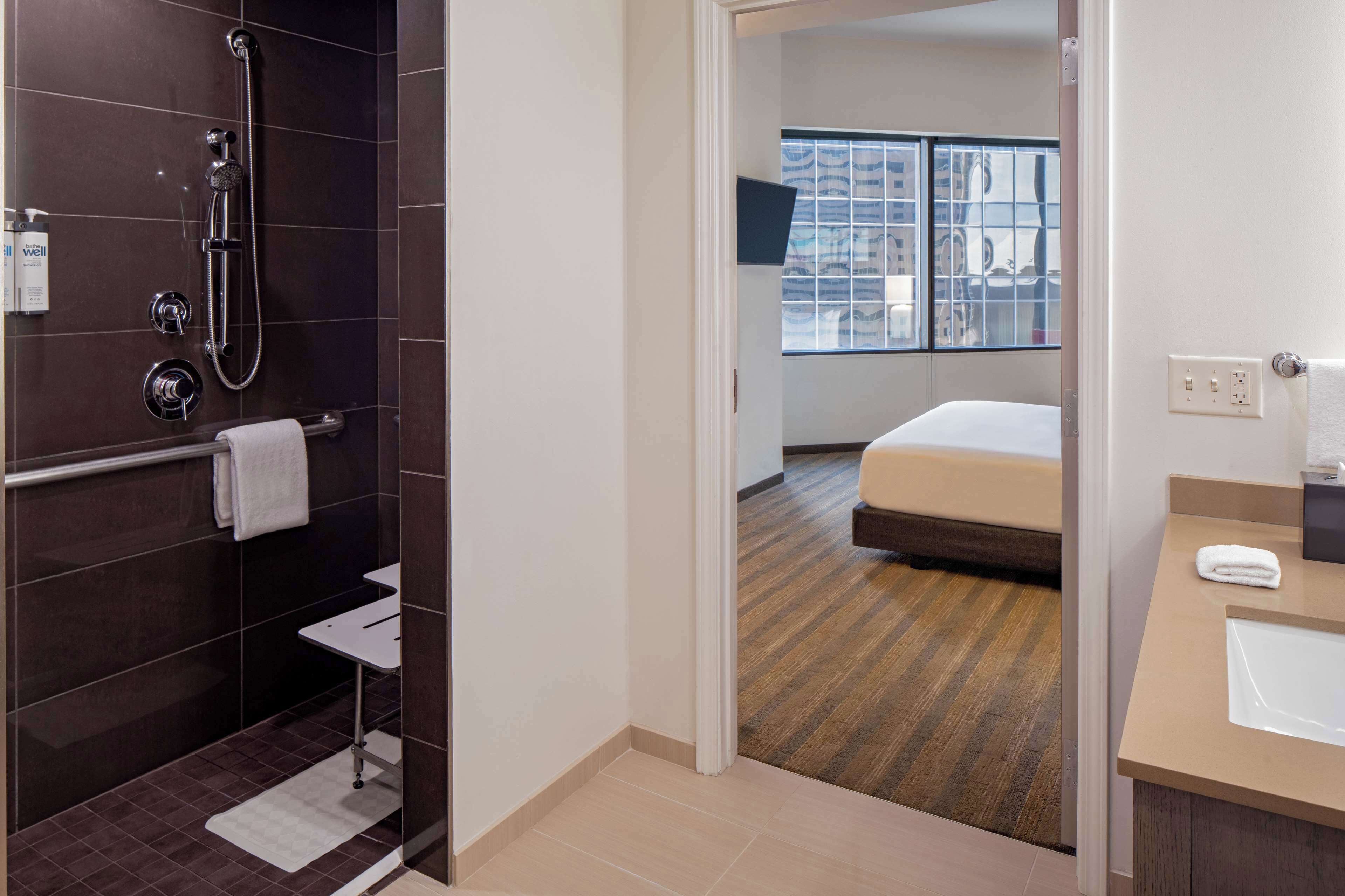 one bedroom suite one king | bathroom | shower, designer toiletries, hair dryer, towels