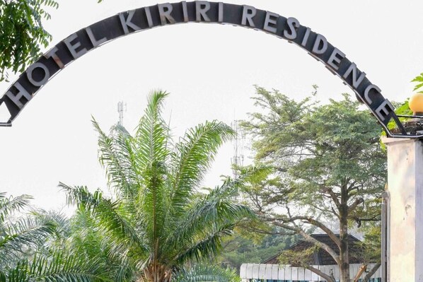 A metal archway with the words 'HOTEL KIRIRI RESIDENCE' inscribed on it.
