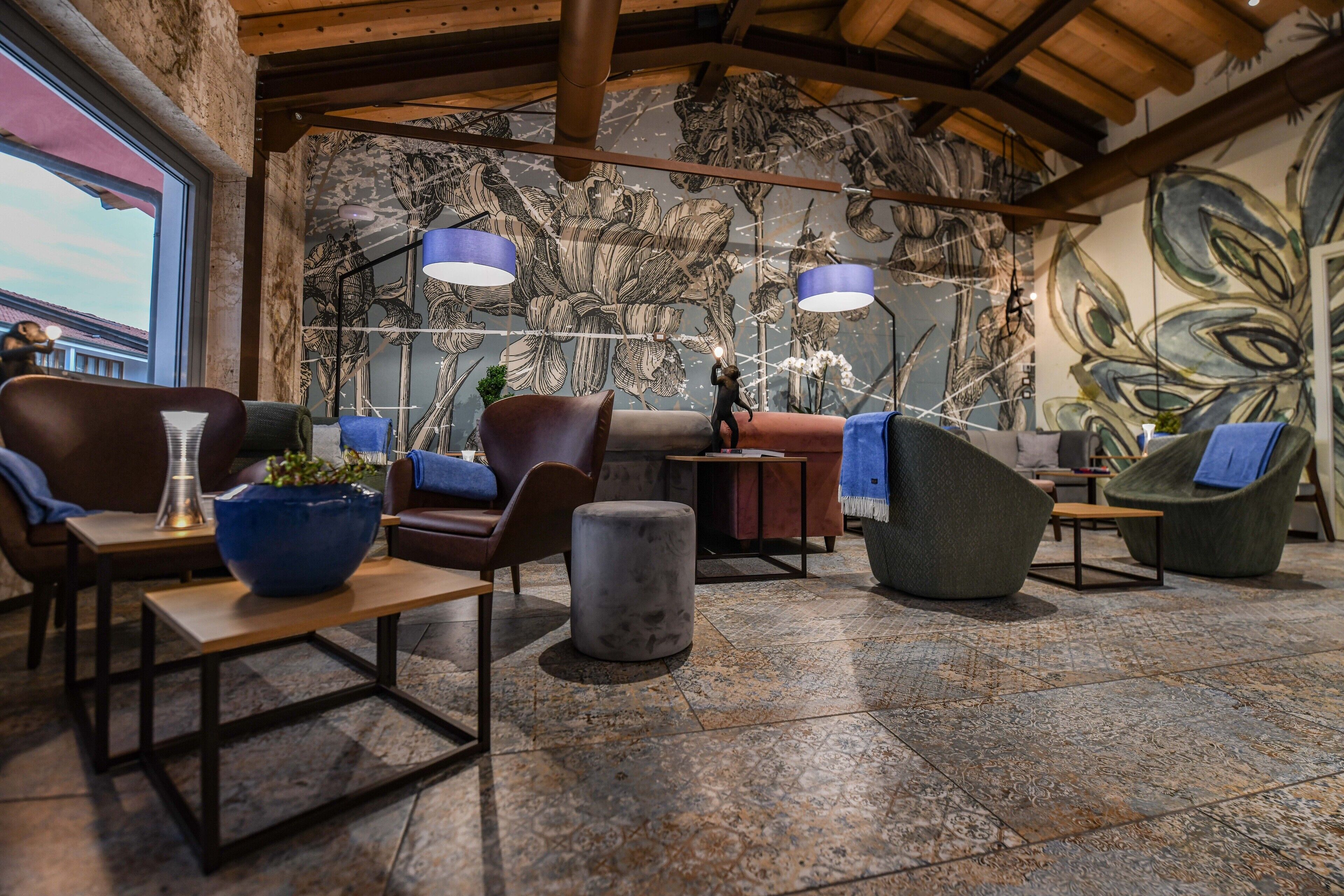 A modern lounge area with leather sofas, a coffee table, and a blue vase.