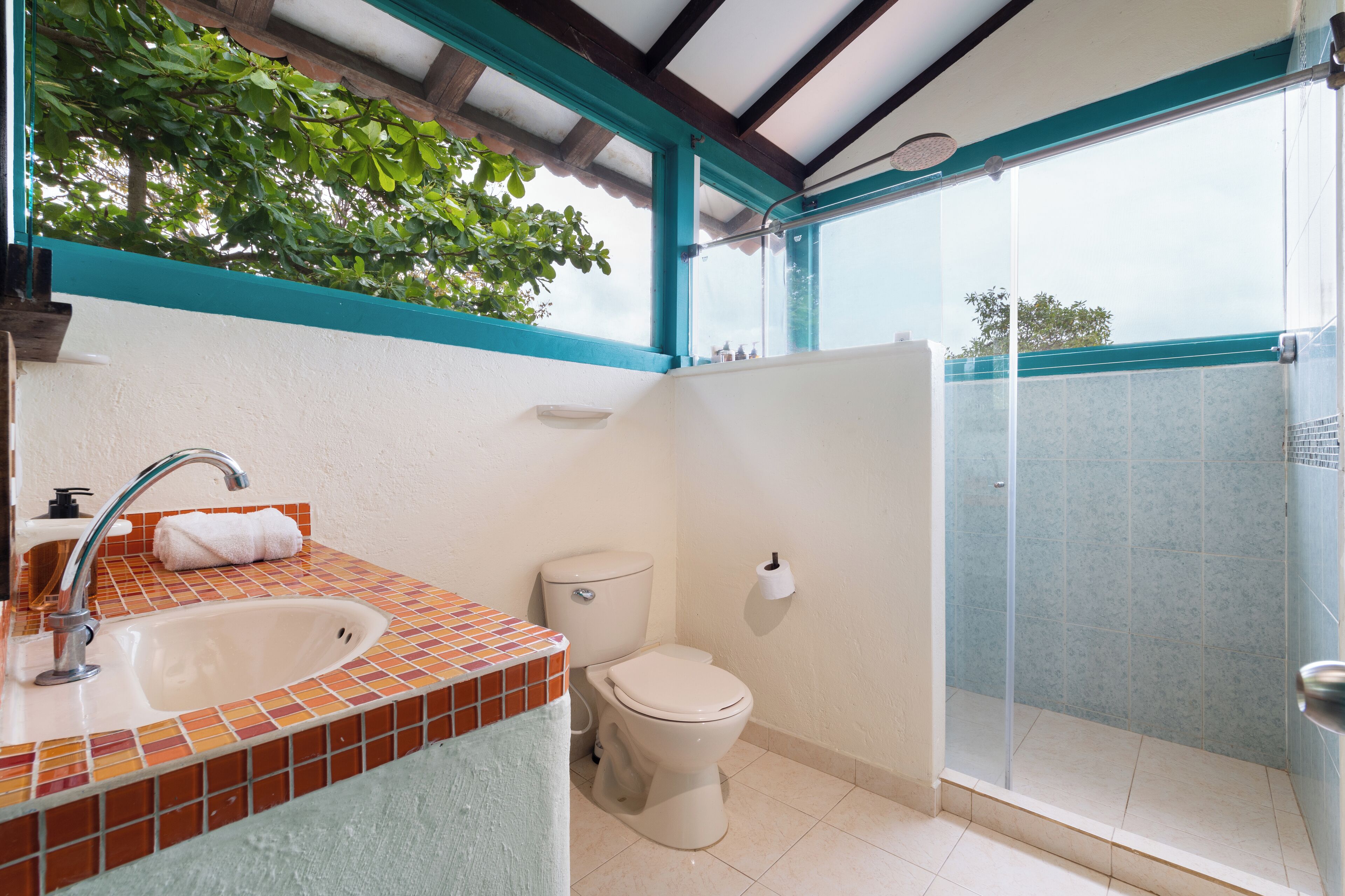 A bathroom with a sink, toilet, and shower.