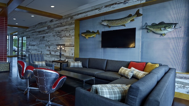 A modern living room with a fireplace, a large sofa, and a wall-mounted TV. - Eddy's Resort (Onamia)