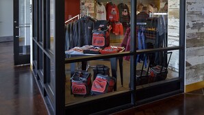 A glass-fronted store with clothing and bags.