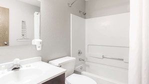 Een moderne badkamer met een witte wastafel, toilet en bad.