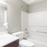 A bathroom with a toilet, sink, and bathtub.