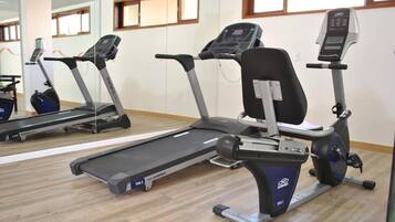 A gym with treadmills and elliptical machines.