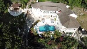 A large house with a swimming pool, a covered deck, and a satellite dish. - Sea Symphony Villa (Fryers Well)