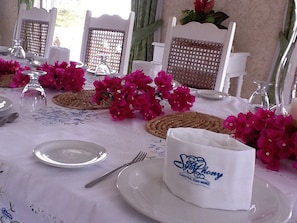 A table set with white plates, cutlery, and a napkin with 'SeaPhony' branding.
