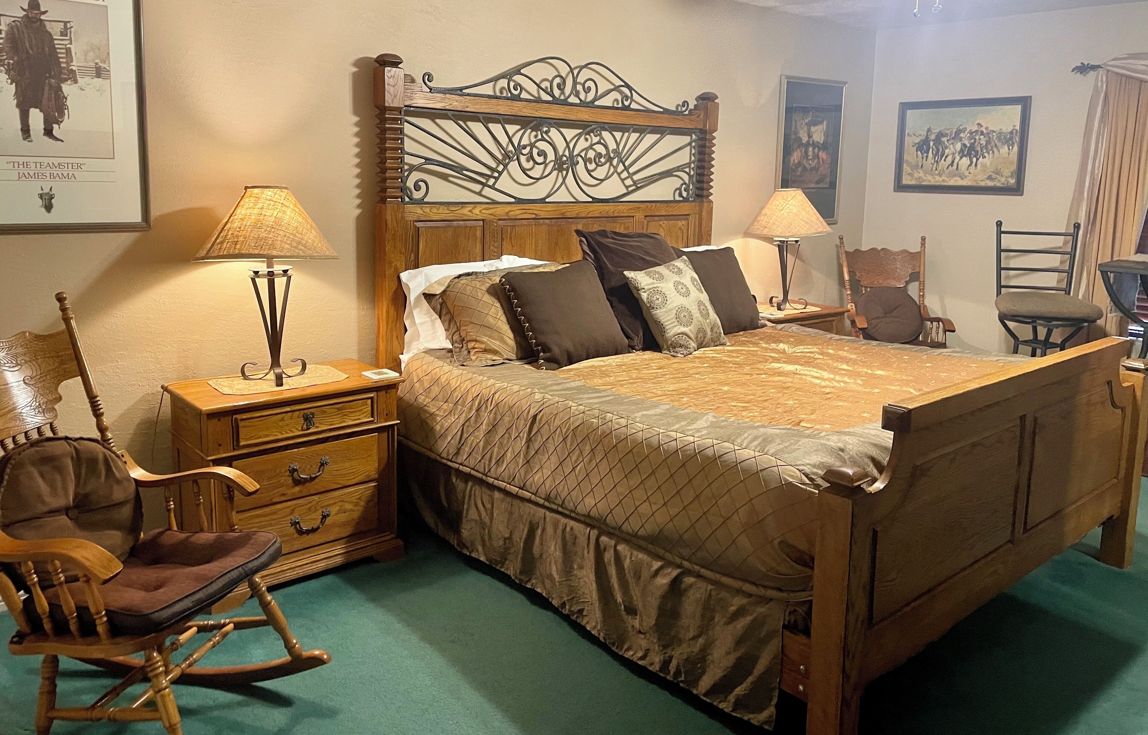 A neatly arranged bedroom with a wooden bed, two nightstands, a rocking chair, and a wooden dresser.