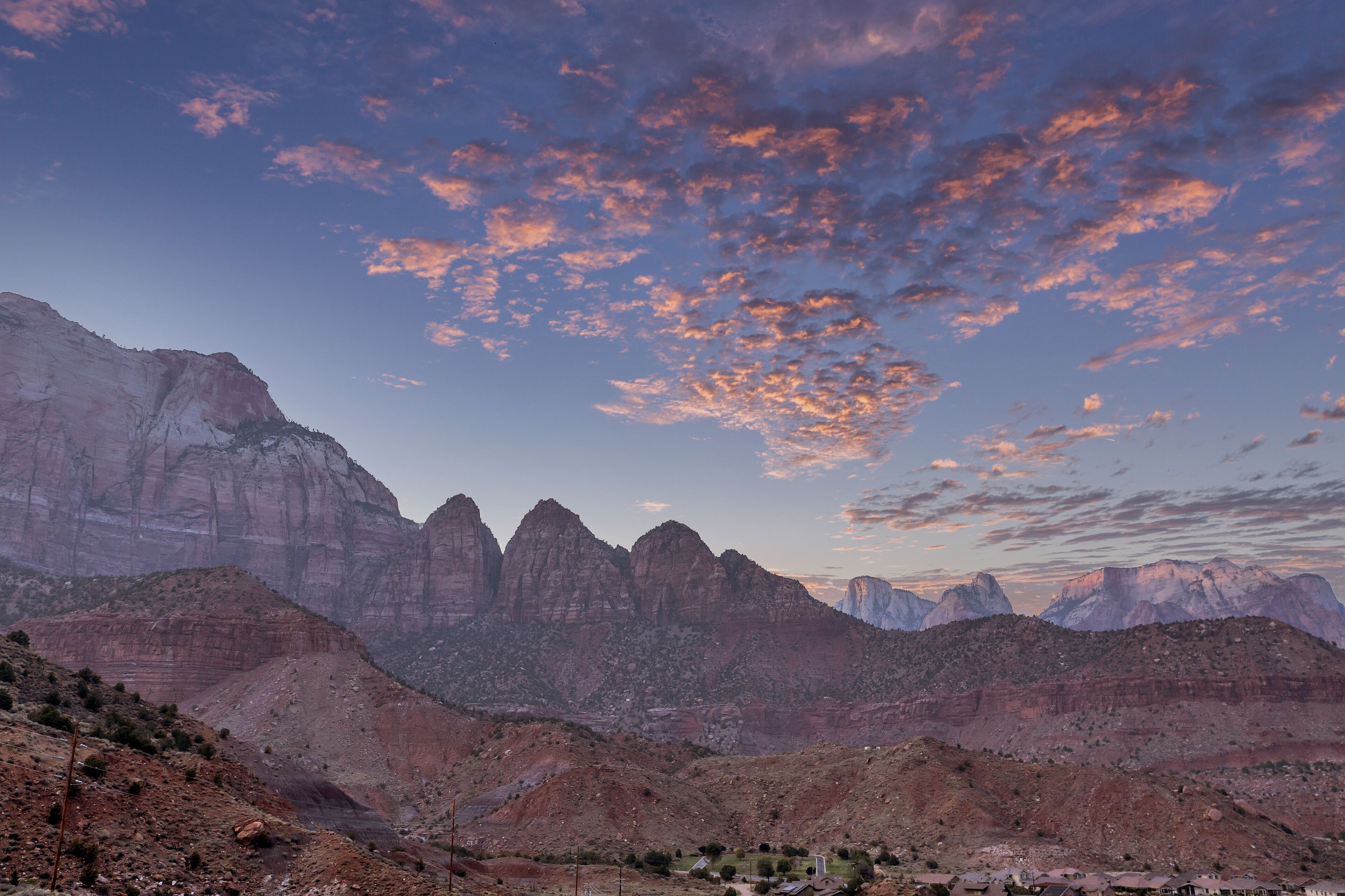 A mountainous landscape with rocky terrain and a small settlement in the valley.