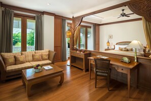 Prestige Suite | Living area | 32-inch LCD TV with cable channels, TV, books - Dheva Mantra Resort (Kanchanaburi)
