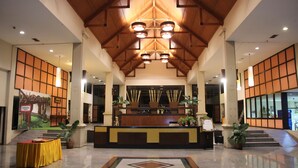 A spacious lobby with a reception desk, potted plants, and a tiled floor. - Aekpailin River Kwai Resort Kanchanaburi (Kanchanaburi)