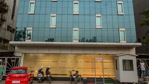 A modern building with a sign reading "Ginger Hotel" above the entrance. - Ginger Ahmedabad, Satellite (Ahmedabad)
