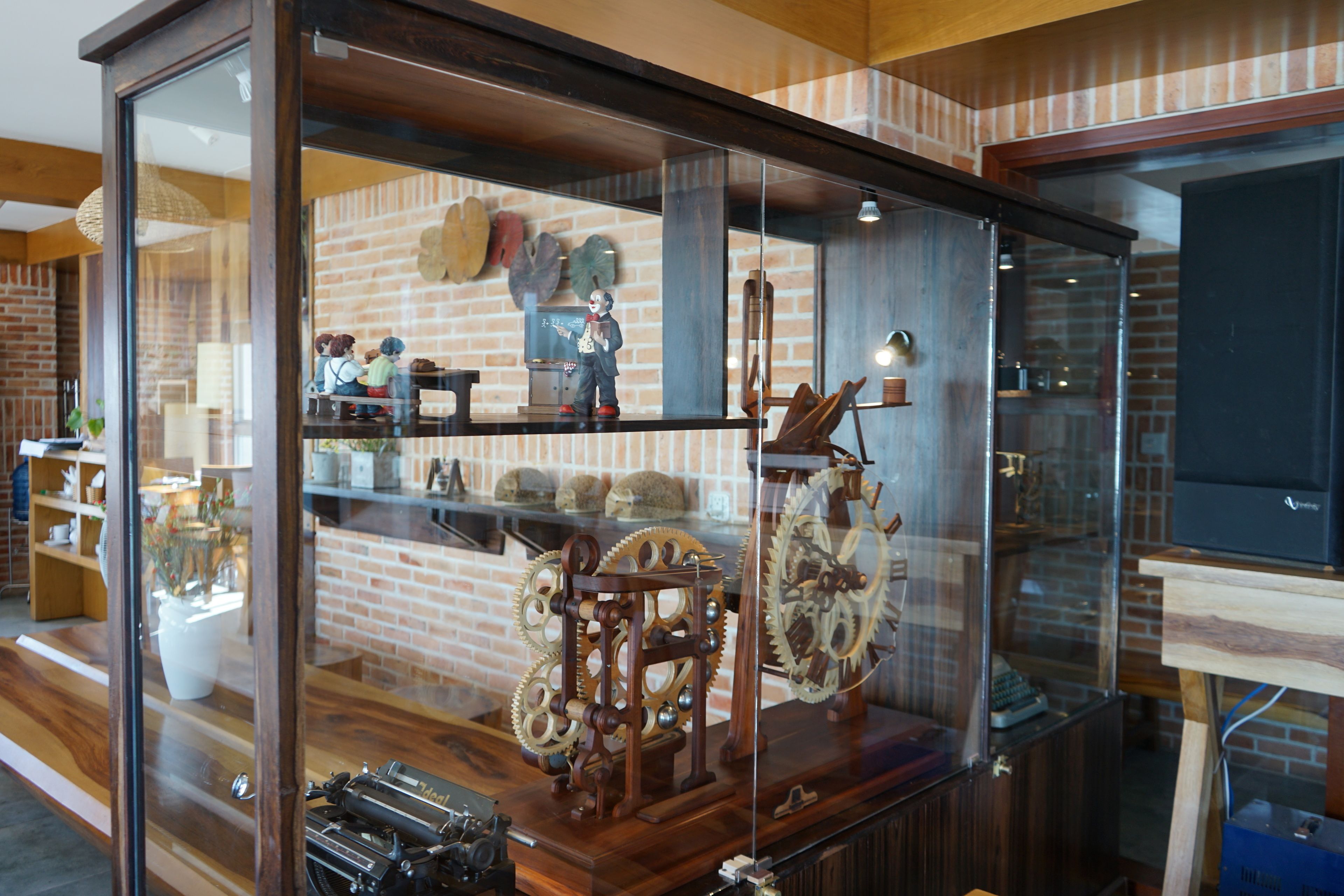 A display case with antique mechanical toys and gears.